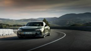 A 2025 Audi RS e-tron GT Performance takes a corner at speed.