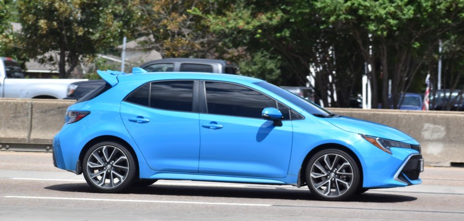 Blue Toyota GR Corolla hatchback driving on the interstate.