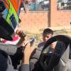 Polaris Factory Racing driver Brock Heger passes out stickers to kids in Ojos Negros.