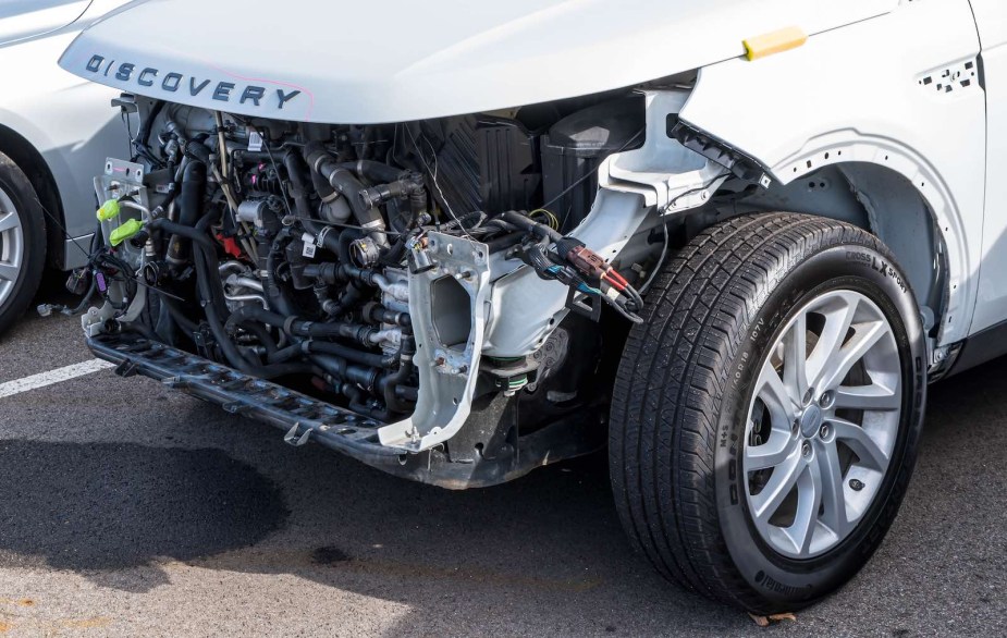 Closeup of front-end damage on white Land Rover SUV