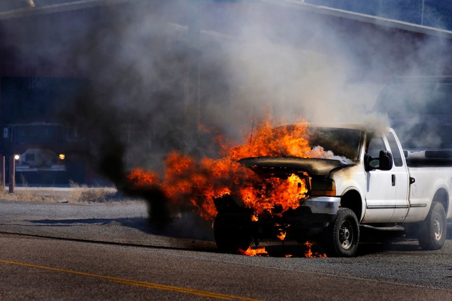 White Ford truck burning because of a runaway diesel engine.