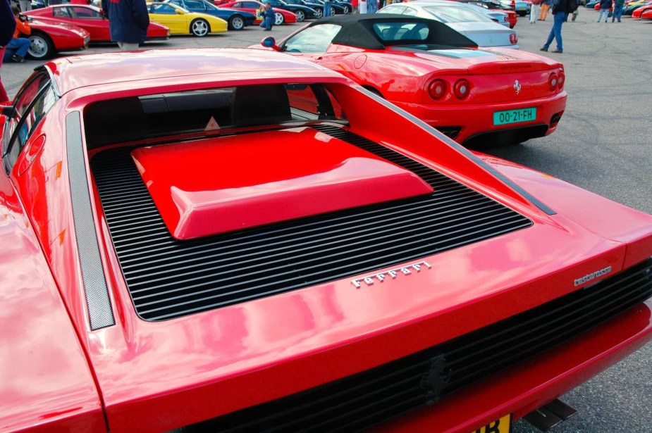 The back of a red Ferrari Testarossa at a car show.