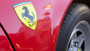 Yellow logo on a classic Ferrari car.