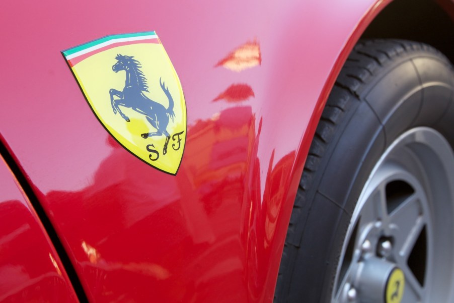 Yellow logo on a classic Ferrari car.