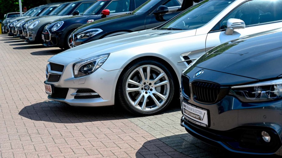 A row of gray, silver, black, and white cars for sale in Europe.