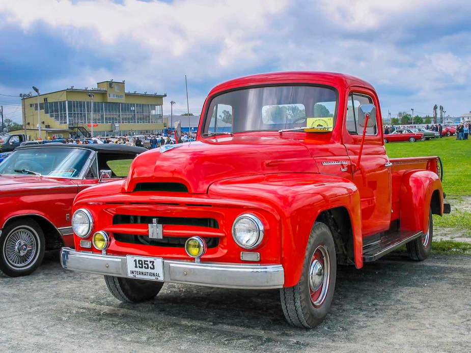 Red International pickup truck parked at a car show