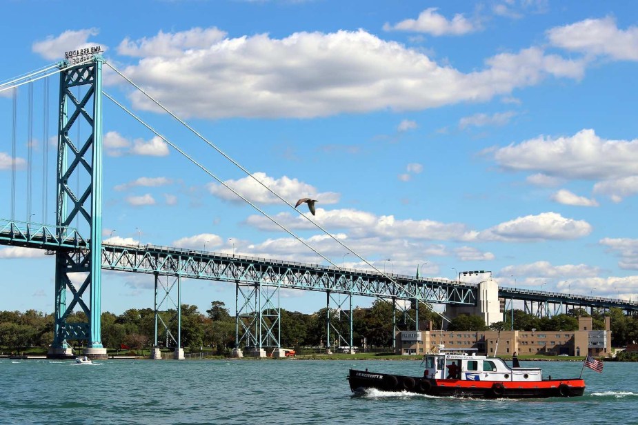 J.W. Westcott II tender boat sails past the Ambassador Bridge in the Detroit River.