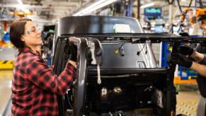 Factory worker in Toledo assembles a Jeep Gladiator pickup truck.