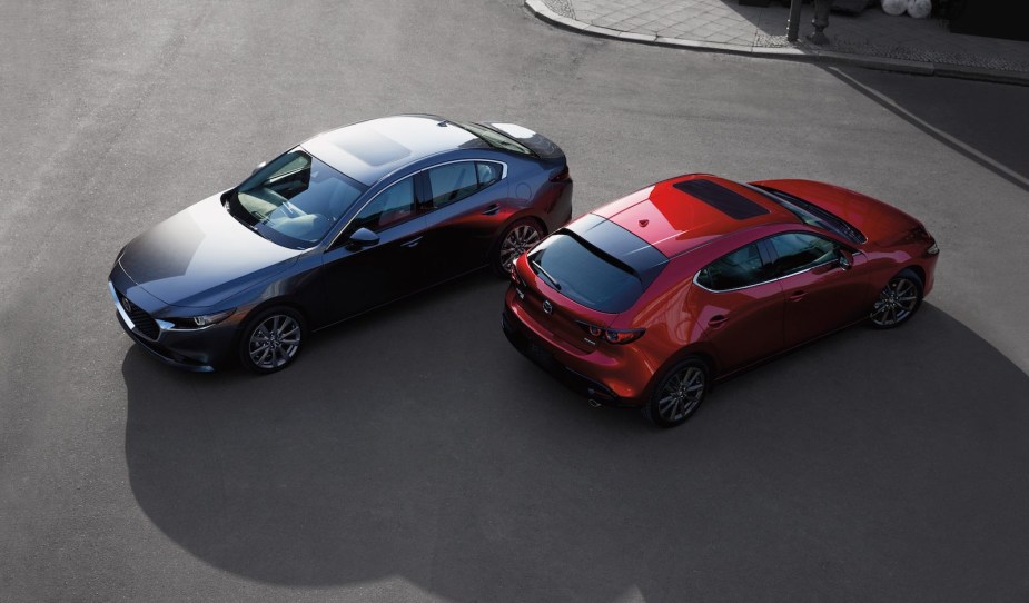 Overhead view of a gray Mazda 3 sedan and a red hatchback