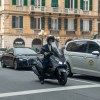 A man riding a moped in the city