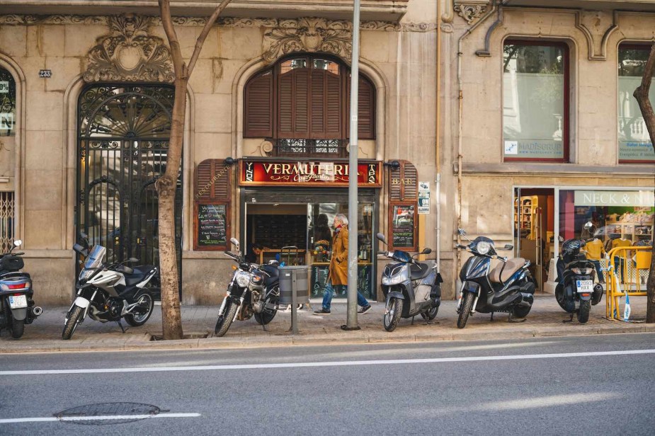 Row of motorcycles parked on the sidewalk in Barcelona