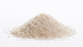 Pile of cooked white rice on a white background.