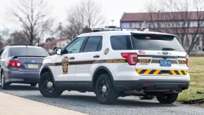 White police cruiser at an angle during a traffic stop.