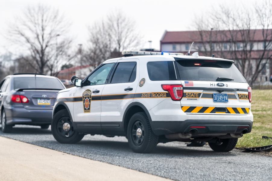 White police cruiser at an angle during a traffic stop.