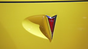 Bright yellow Pontiac car with a red arrow logo.