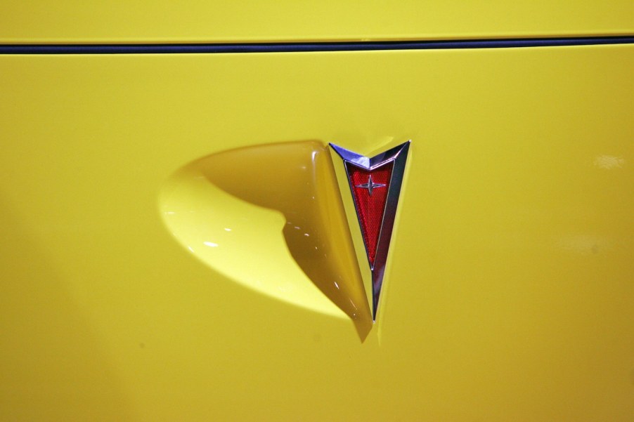 Bright yellow Pontiac car with a red arrow logo.