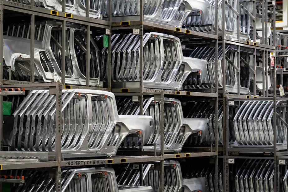 The metal body panels of Rivian R1T electric pickup trucks stacked on shelves at the factory in Normal, Illinois