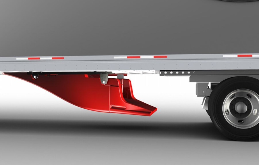 Bright orange "UnderTray" installed on a semi truck trailer for aerodynamics.