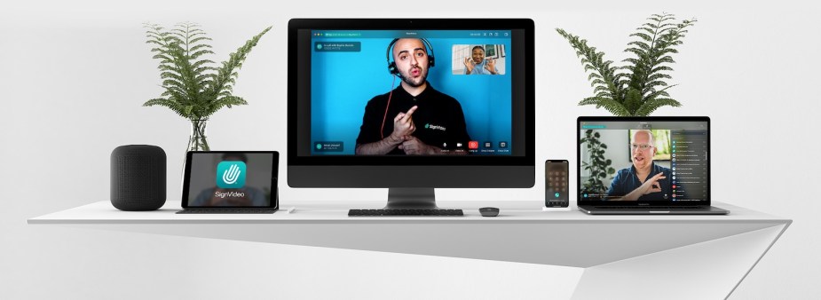 A row of computers and ipads showing Sign Video's British sign language translation services.