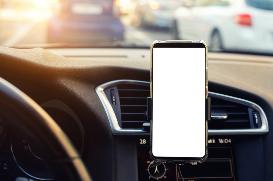 Smartphone running a zoom court meeting from inside a car.