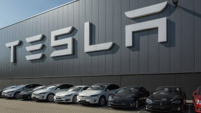 Tesla models parked outside a Tesla building