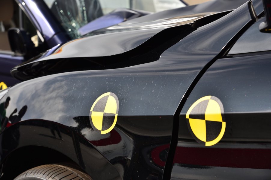 Black car's fender during crash safety test.