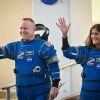 The stranded Boeing Starliner spacecraft crew photographed waving in their blue NASA jumpsuits before launch