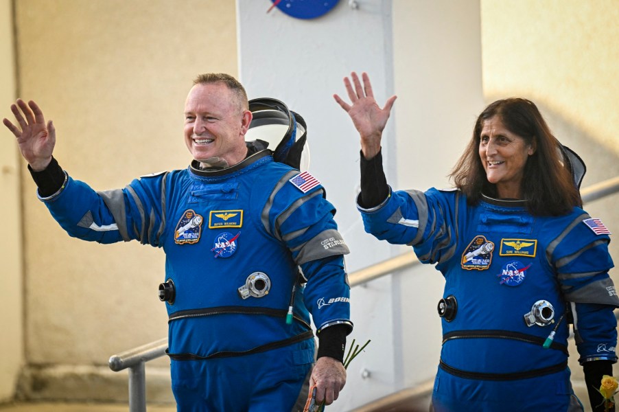 The stranded Boeing Starliner spacecraft crew photographed waving in their blue NASA jumpsuits before launch