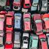 An aerial view of rows of scrapped cars stacked up