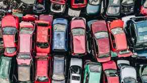 An aerial view of rows of scrapped cars stacked up