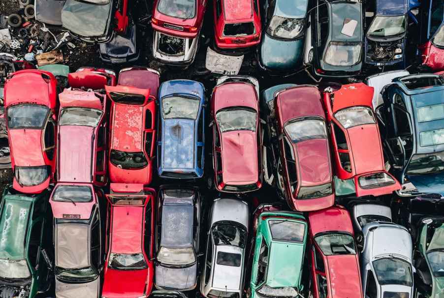 An aerial view of rows of scrapped cars stacked up