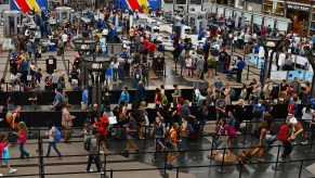 Crowded TSA security lines at Denver International Airport during busy summer travel times