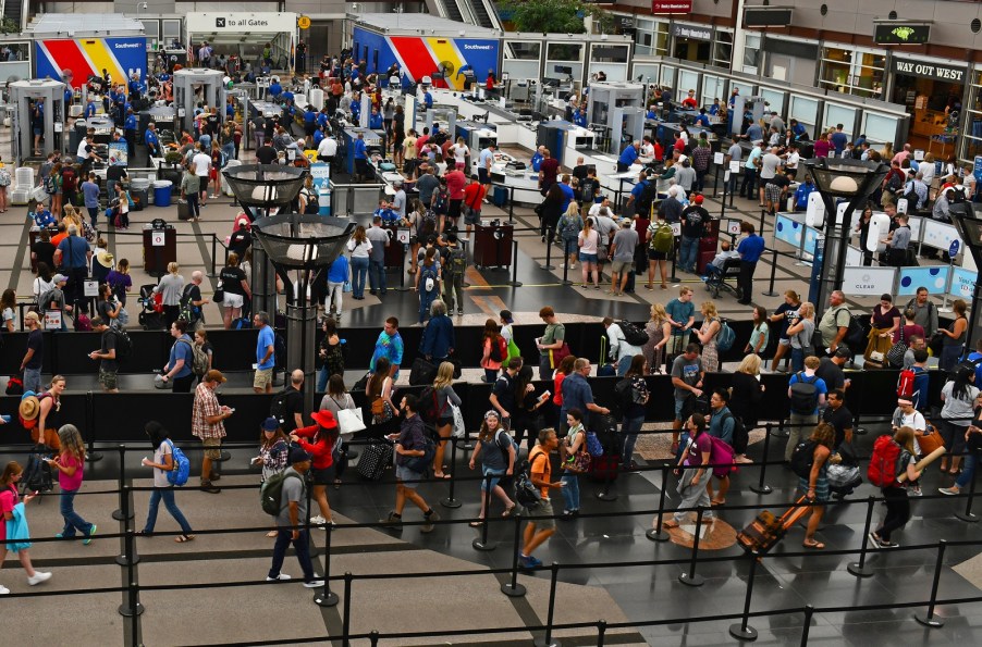 Crowded TSA security lines at Denver International Airport during busy summer travel times