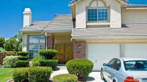 Home with two car garage and BMW parked in driveway, home upgrades can include a replacement garage door which has highest ROI