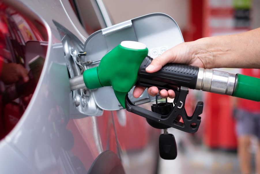 A woman filling a car with gas