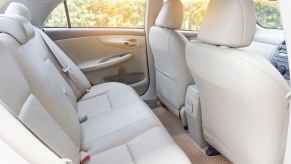 The rear tan leather interior of a new luxury car new car smell can actually be toxic