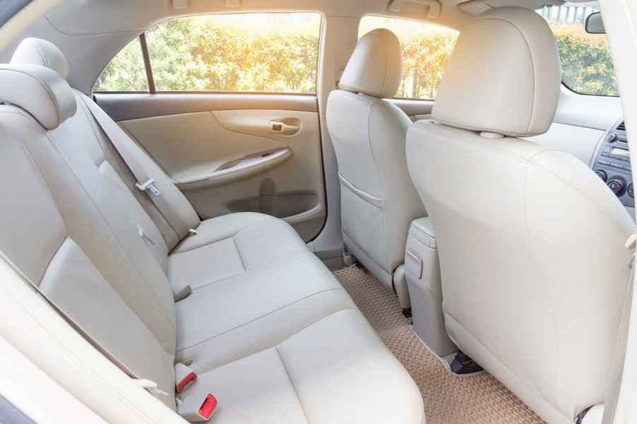 The rear tan leather interior of a new luxury car new car smell can actually be toxic