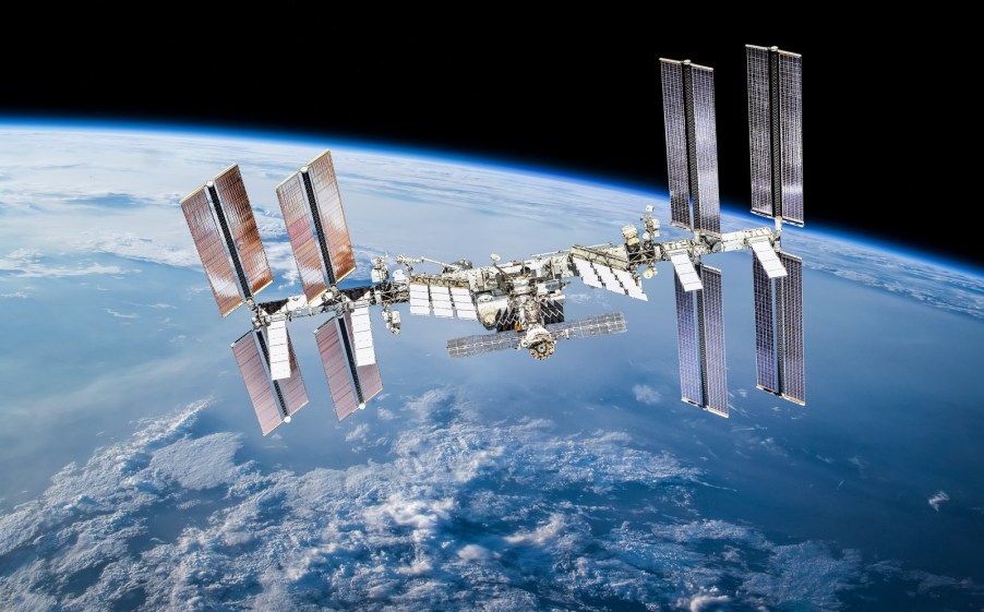 The International Space Station (IIS) shown in full view with Earth visible in background