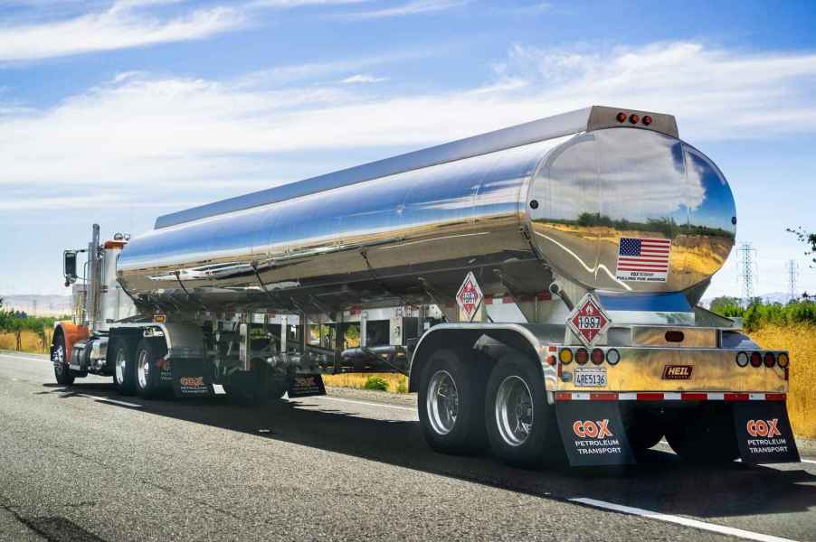 Tanker truck driving on the highway in left rear angle view