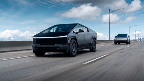 Tesla Cybertruck drives in front of another Cybertruck on a freeway