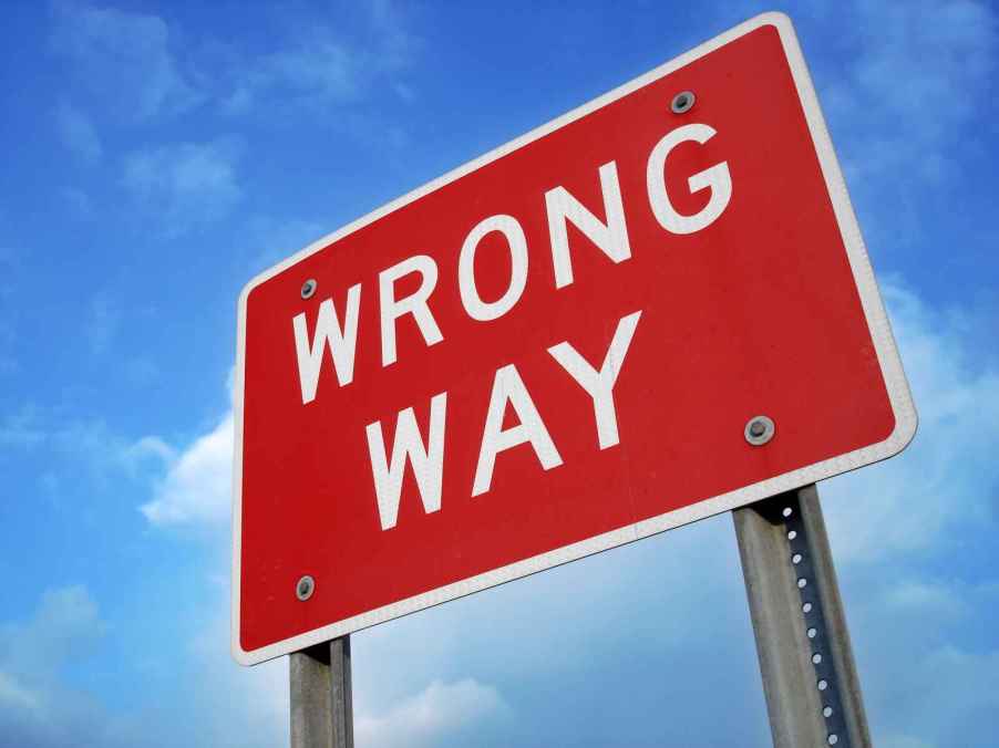 A red "wrong way" road sign