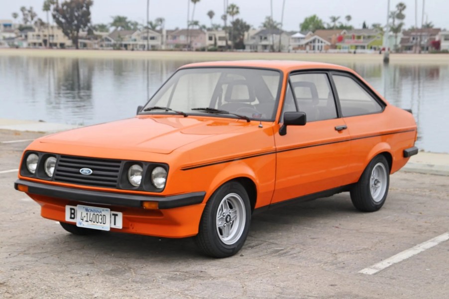 An orange 1978 Ford Escort parked in left front angle view a crew of British Royal Marines holds the record for fastest engine swap and used a Ford Escort in 1985