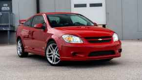 A red 2009 Chevrolet Cobalt SS Turbo parked in right front angle view with front wheel turned in, it's one of Reddit's "forgotten but most fun cars."