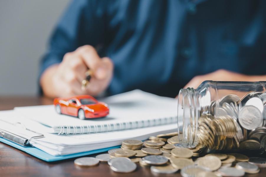 An agent works on car insurance rates as they sort out a policy.