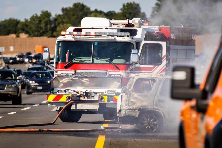 A fire department engine responds to car damage and fire after a motor vehicle accident.