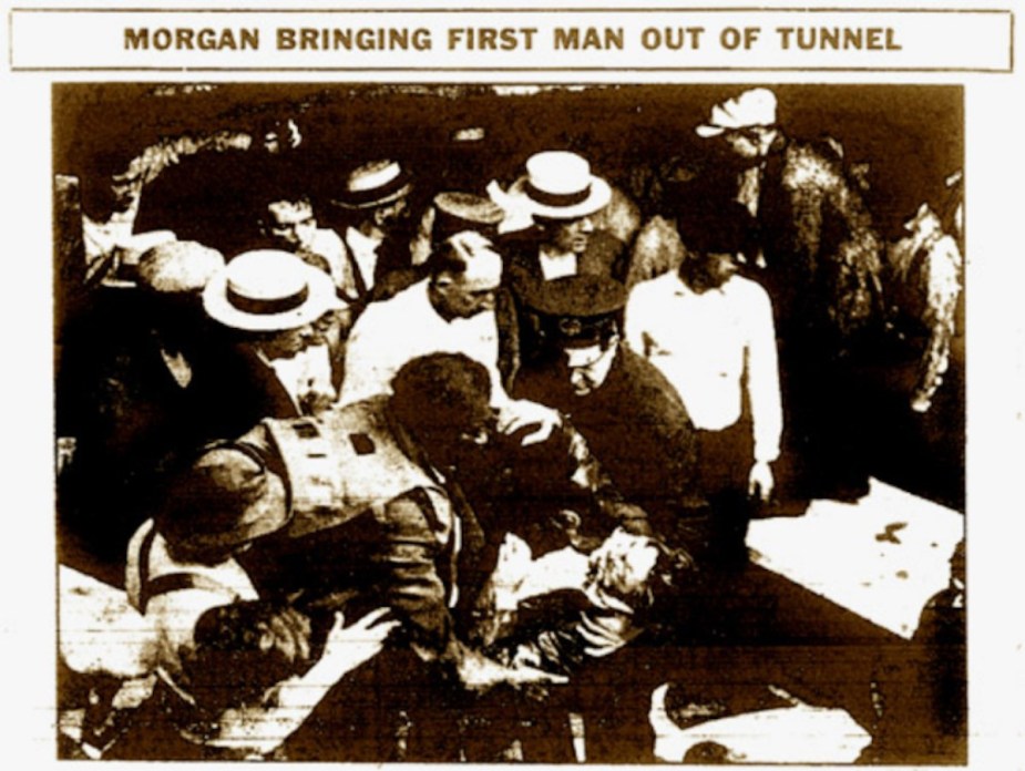 Newspaper clipping shows Garrett Morgan rescuing a tunnel worker with his gas mask.