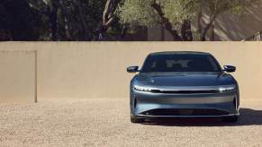 A Lucid Air Pure, the most efficient car in the world, parks on gravel.