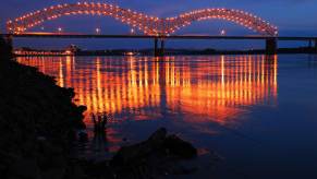 The lgihts on a bridge in Memphis, Tennessee, reflected in the Mississippi river.