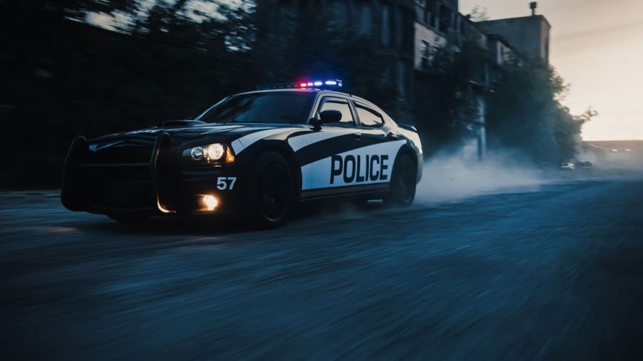 A police officer drives a Dodge Charger after completing driver training.