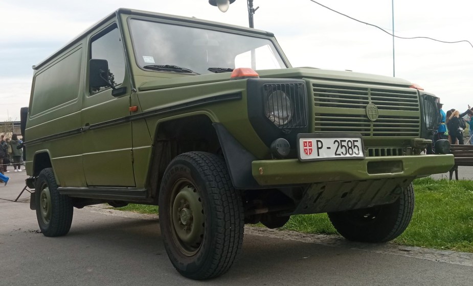 Green military spec G Wagon  with a Puch logo visible on its grille